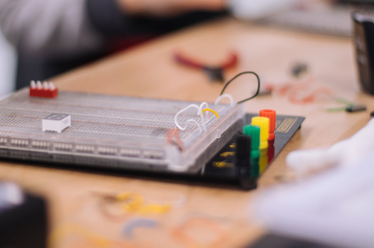 Detailed view of an electronic breadboard setup on a workbench, ideal for STEM education.
